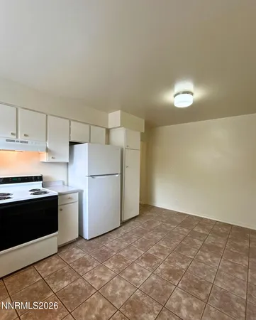 a kitchen with a stove top oven and cabinets