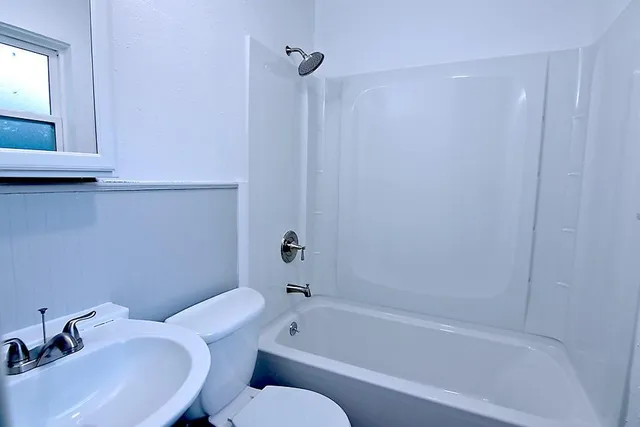 a bathroom with a sink toilet and bathtub