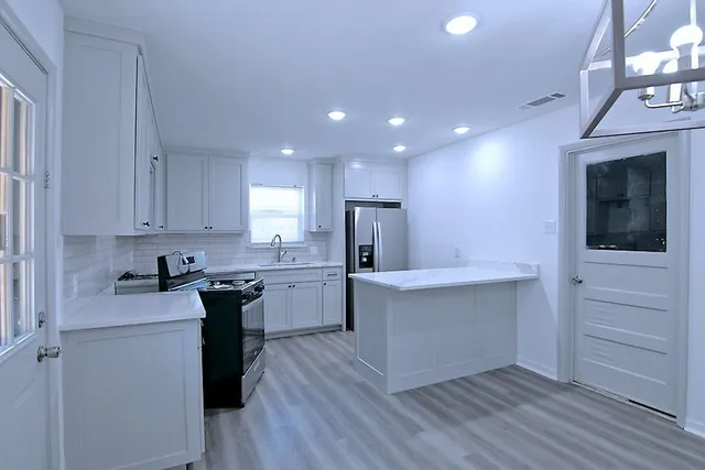 a kitchen with a sink and cabinets