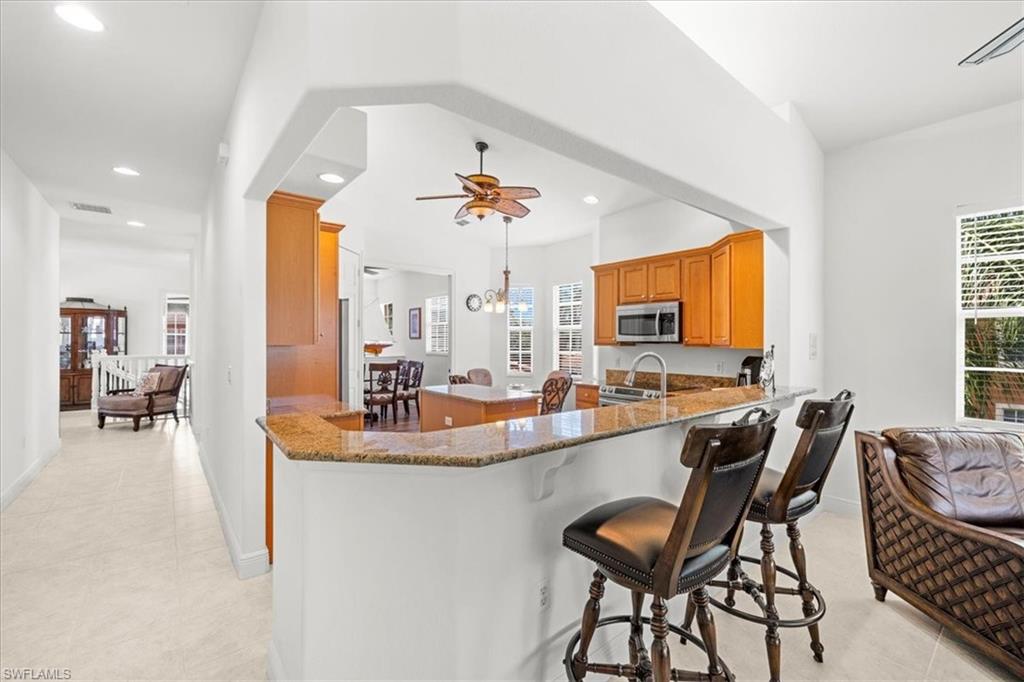 6443 Legacy Circle, Unit 1103 Naples, FL 34113 - Photo 13 of 35 a dining room with furniture and window