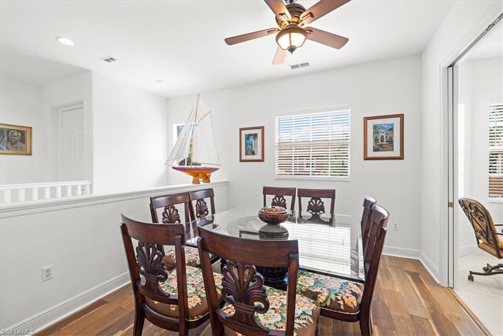 6443 Legacy Circle, Unit 1103 Naples, FL 34113 - Photo 14 of 35 a view of a dining room with furniture window and wooden floor
