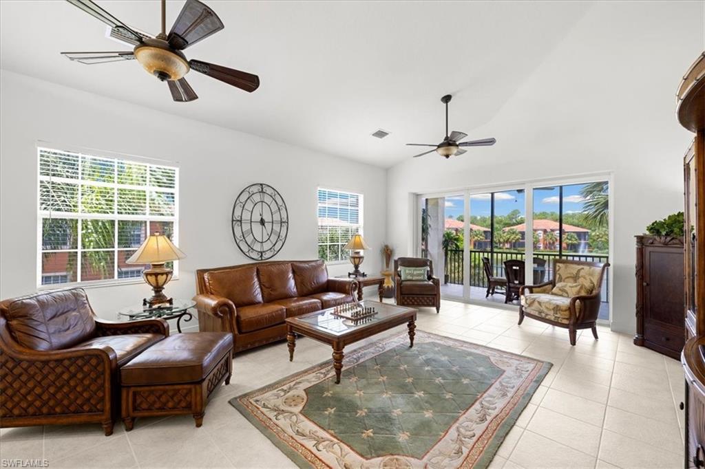 6443 Legacy Circle, Unit 1103 Naples, FL 34113 - Photo 17 of 35 a living room with furniture a ceiling fan and a large window