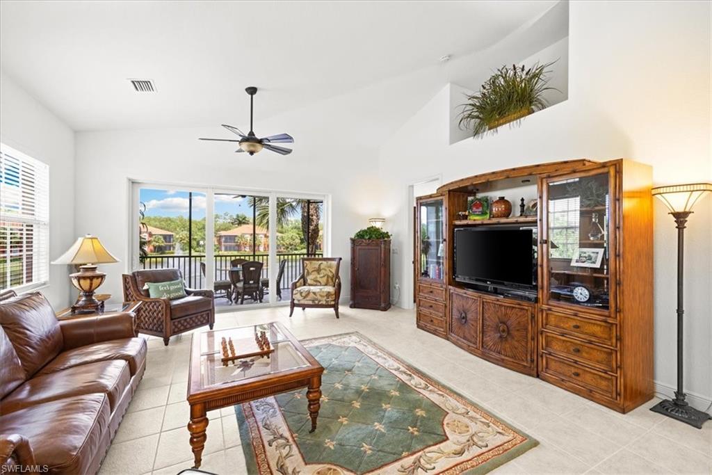 6443 Legacy Circle, Unit 1103 Naples, FL 34113 - Photo 19 of 35 a living room with furniture and a flat screen tv