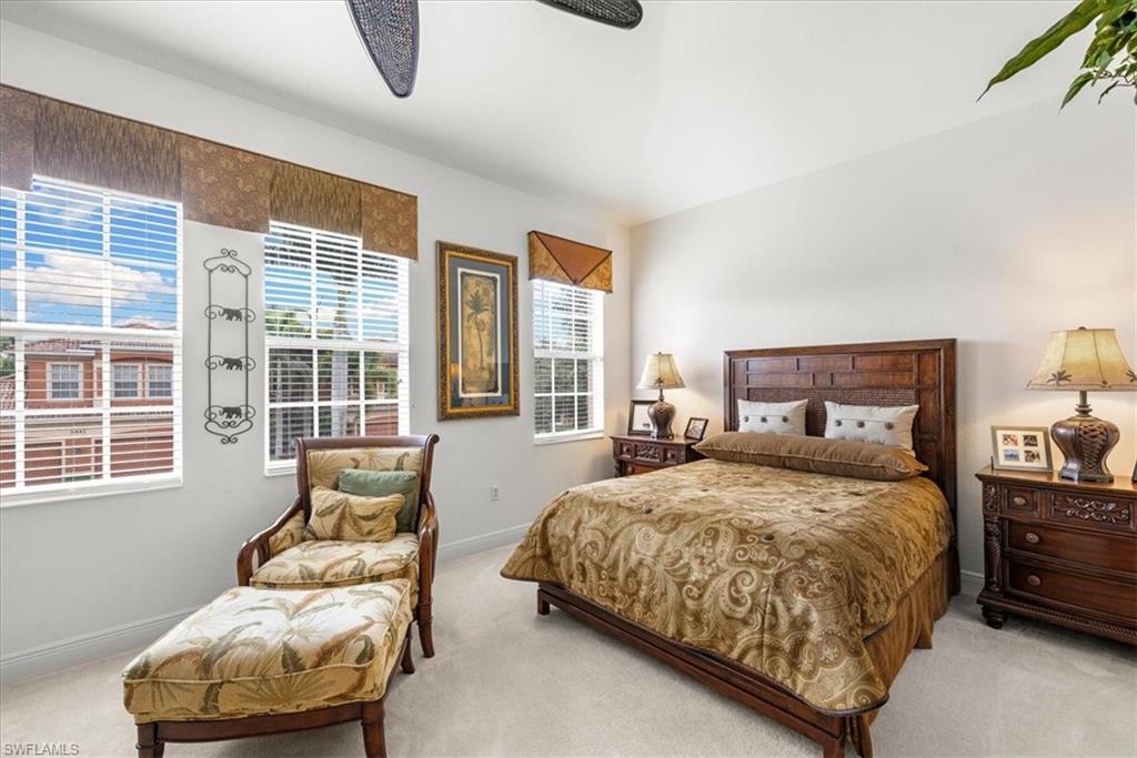 6443 Legacy Circle, Unit 1103 Naples, FL 34113 - Photo 26 of 35 a bedroom with bed couch and window