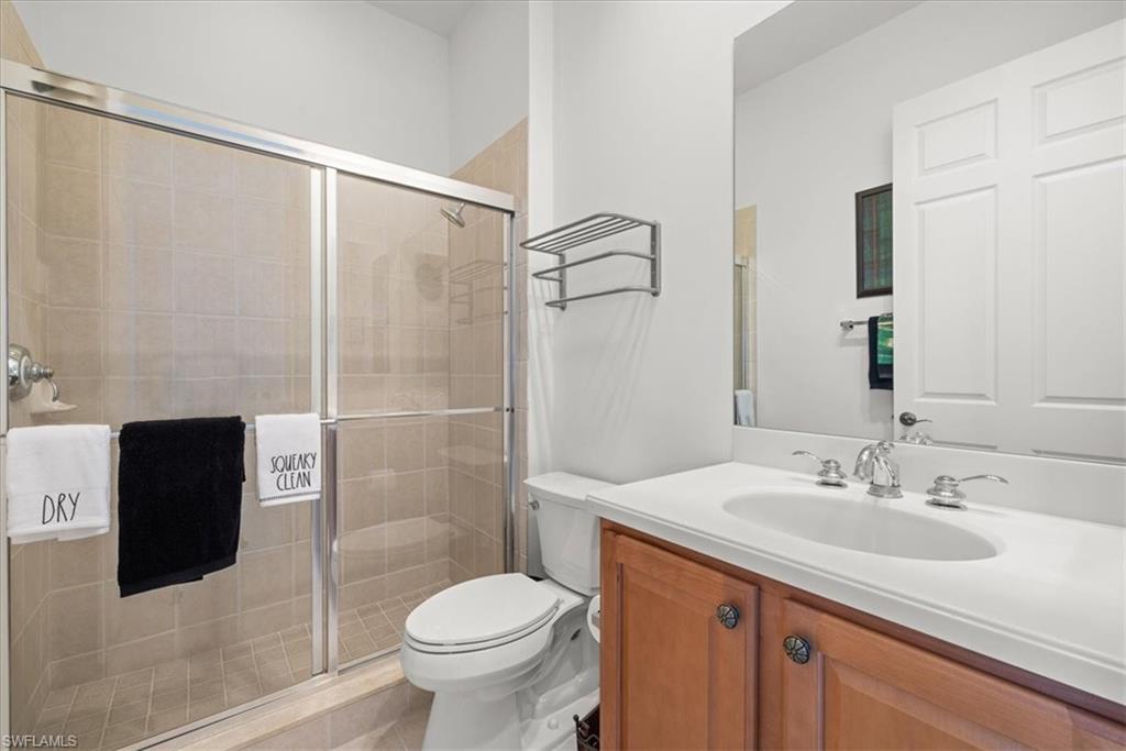 6443 Legacy Circle, Unit 1103 Naples, FL 34113 - Photo 28 of 35 a bathroom with a sink toilet and shower