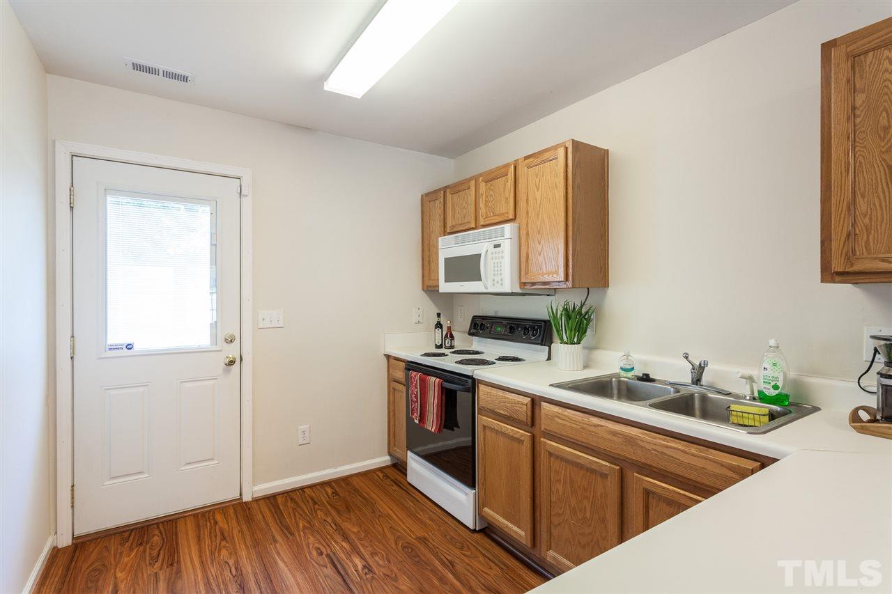 4040 Pearl Road Raleigh, NC 27610 - Photo 5 of 15 Laminate flooring in kitchen area. Refrigerator conveys.