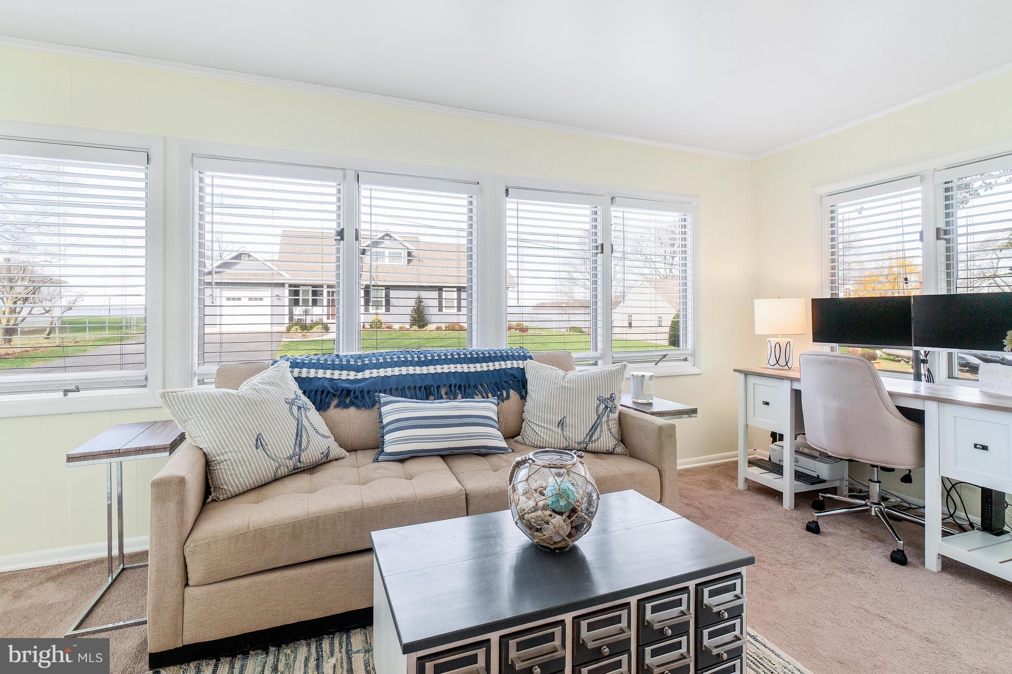 76 Bluff Road Earleville, MD 21919 - Photo 14 of 16 a living room with furniture a flat screen tv and a large window