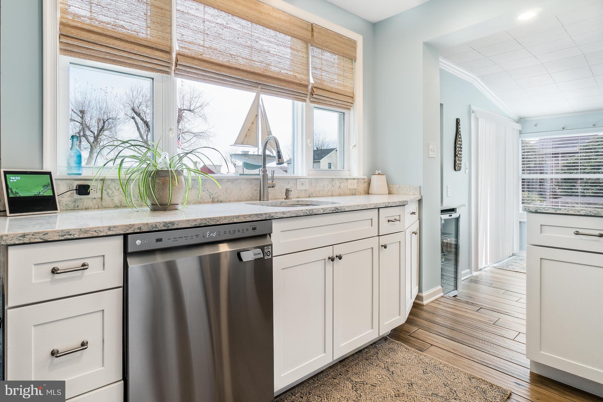 76 Bluff Road Earleville, MD 21919 - Photo 5 of 16 a kitchen with stainless steel appliances white cabinets and a large window