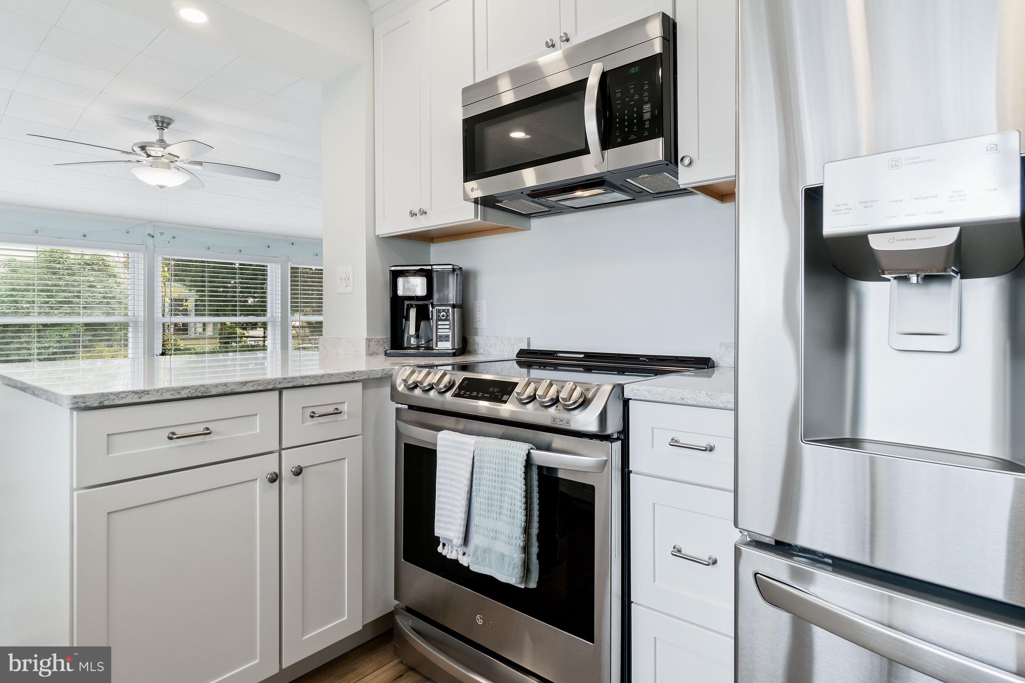76 Bluff Road Earleville, MD 21919 - Photo 6 of 16 a kitchen with stainless steel appliances white cabinets and a stove