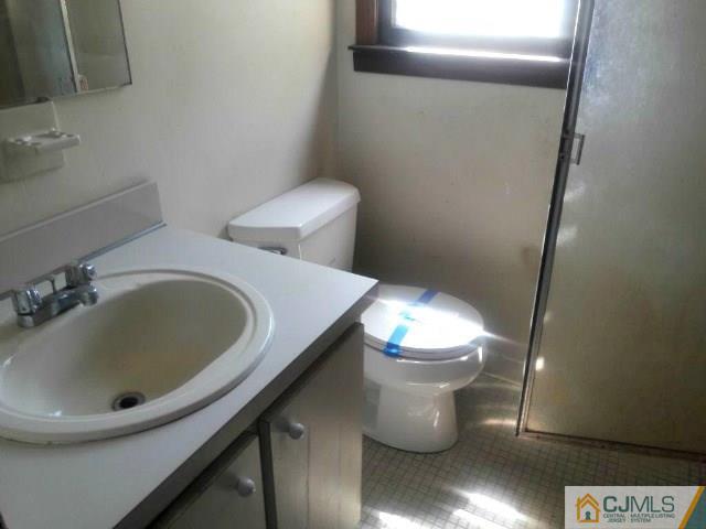 18 Ash Road Edison, NJ 08817 - Photo 17 of 25 a bathroom with a sink and a toilet
