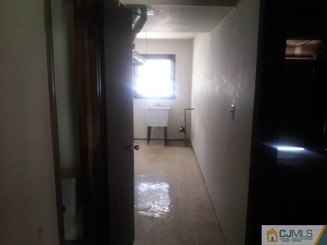 18 Ash Road Edison, NJ 08817 - Photo 20 of 25 a view of a hallway with white walls and a black gate