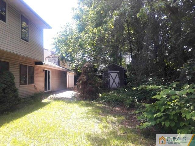 18 Ash Road Edison, NJ 08817 - Photo 22 of 25 a backyard of a house with yard and outdoor seating
