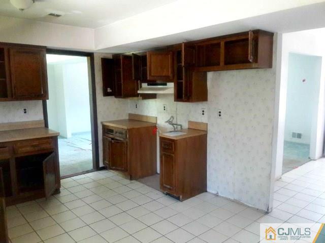 18 Ash Road Edison, NJ 08817 - Photo 8 of 25 a kitchen with stainless steel appliances granite countertop a stove and a refrigerator