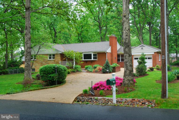 a front view of a house with a yard and a garage