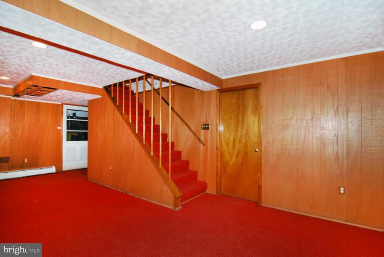 6425 Lignum Street Springfield, VA 22150 - Photo 12 of 30 a view of an empty room with wooden floor and stairs