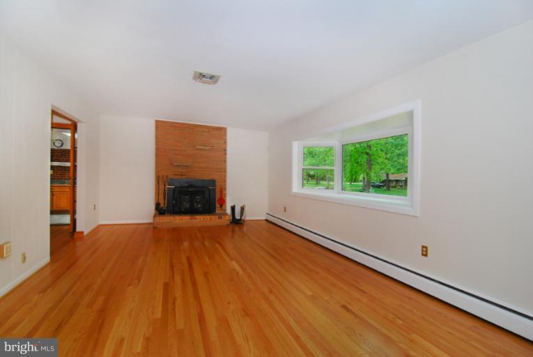 6425 Lignum Street Springfield, VA 22150 - Photo 15 of 30 a view of an empty room with a window and a fireplace