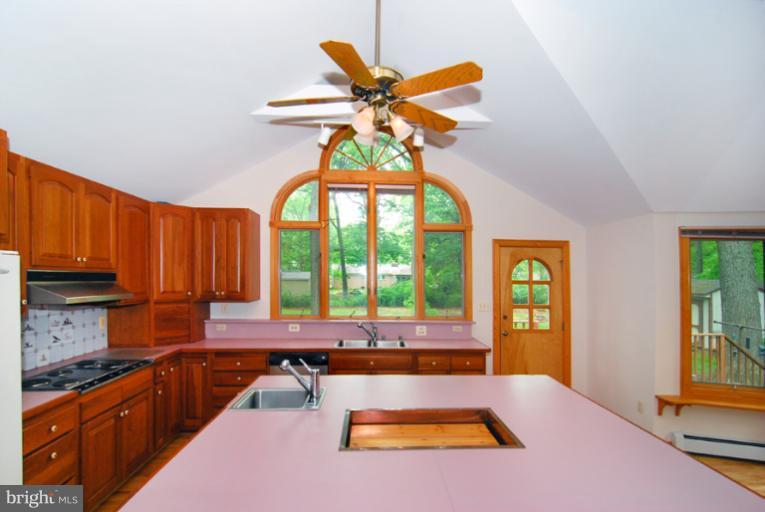 6425 Lignum Street Springfield, VA 22150 - Photo 3 of 30 a kitchen with a refrigerator a sink and cabinets