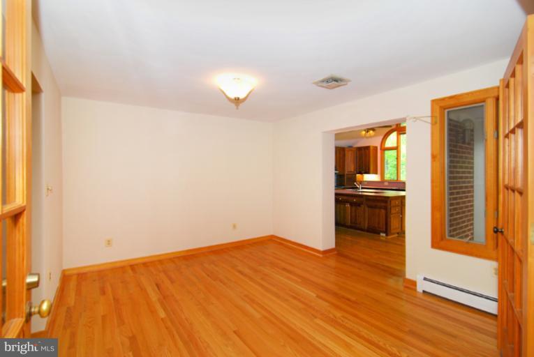 6425 Lignum Street Springfield, VA 22150 - Photo 22 of 30 a view of kitchen and empty room with wooden floor