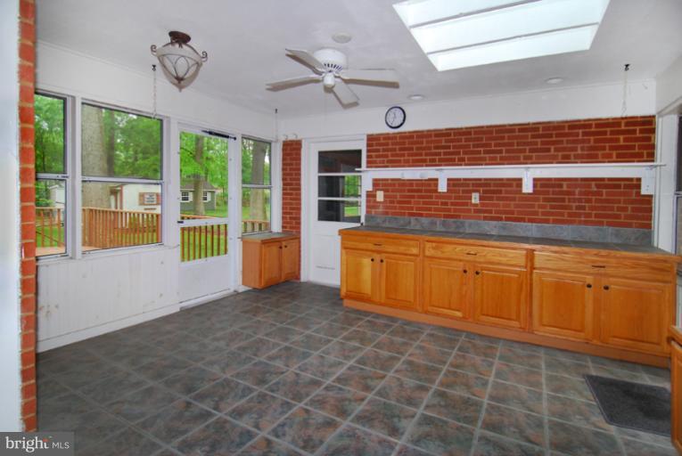 6425 Lignum Street Springfield, VA 22150 - Photo 5 of 30 a view of a kitchen with cabinet and a fireplace