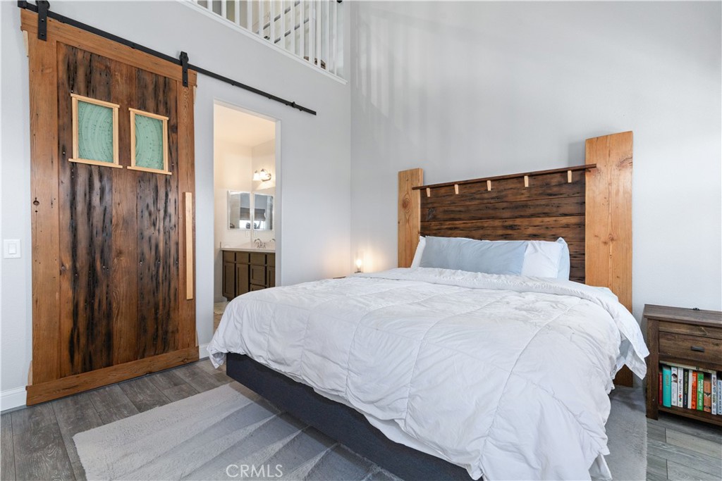 9354 Riberena Circle Atascadero, CA 93422 - Photo 31 of 47 a bedroom with a bed and wooden floor