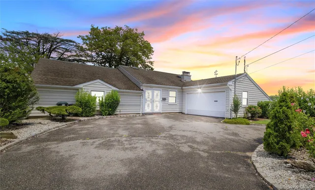 a view of a house with a yard and garage