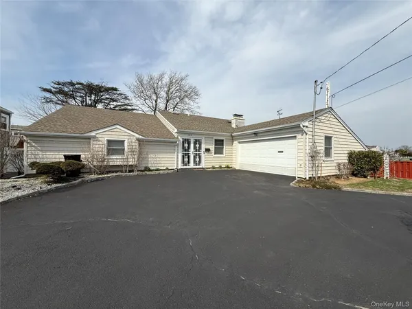 a view of a house with a yard and garage