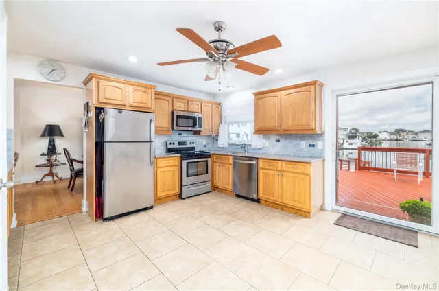 a kitchen with granite countertop a refrigerator and a sink