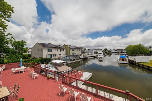 a view of a patio with chairs and potted plants