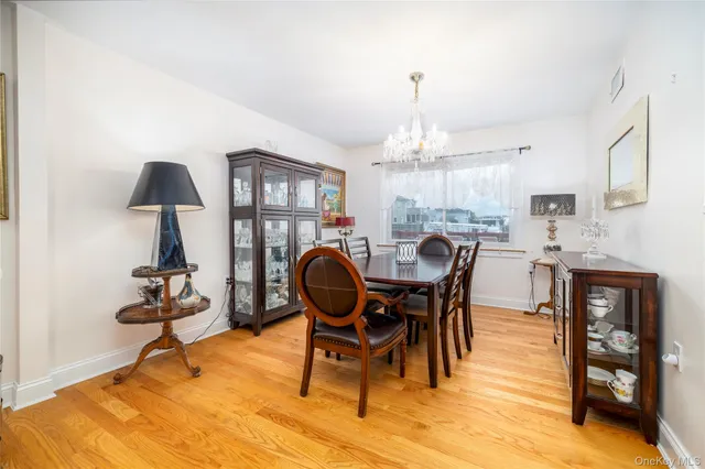 a dining room with furniture a chandelier and window
