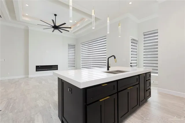 a kitchen with a sink dishwasher a stove a refrigerator and white cabinets with wooden floor