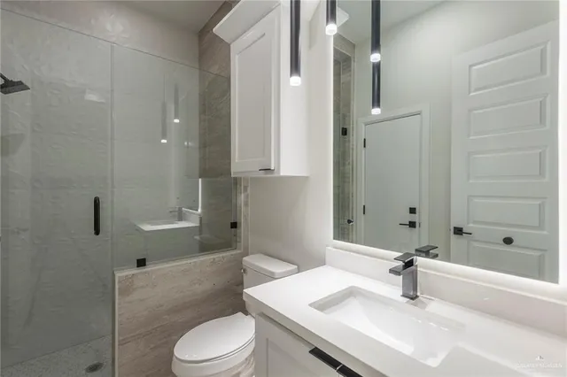 a view of a kitchen with white cabinets and a window