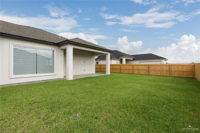 a view of a house with backyard and porch