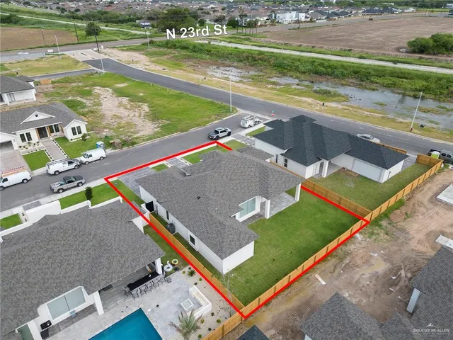 an aerial view of a house with a yard basket ball court and outdoor seating