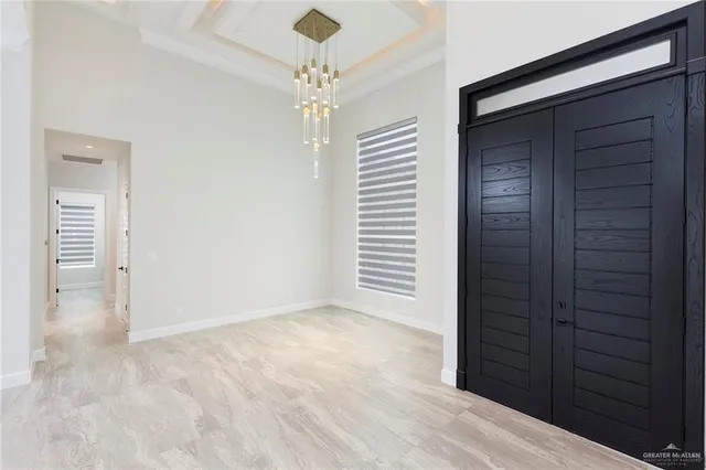 en empty room with windows and entrance