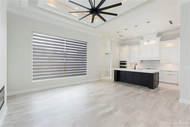 a kitchen with granite countertop a sink and a stove