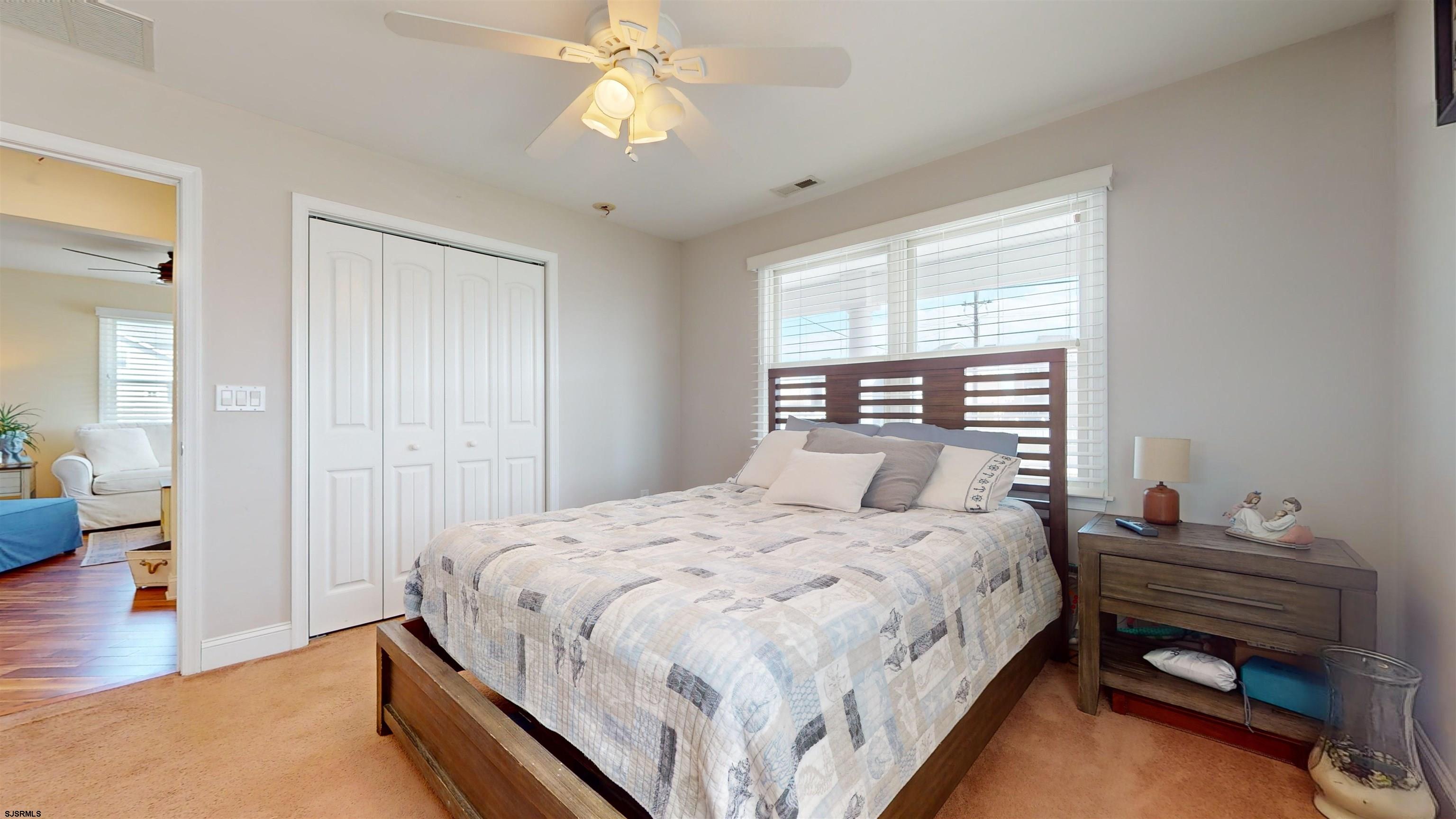4205 Atlantic Brigantine Boulevard Brigantine, NJ 08203 - Photo 19 of 58 a bedroom with a bed and a chandelier