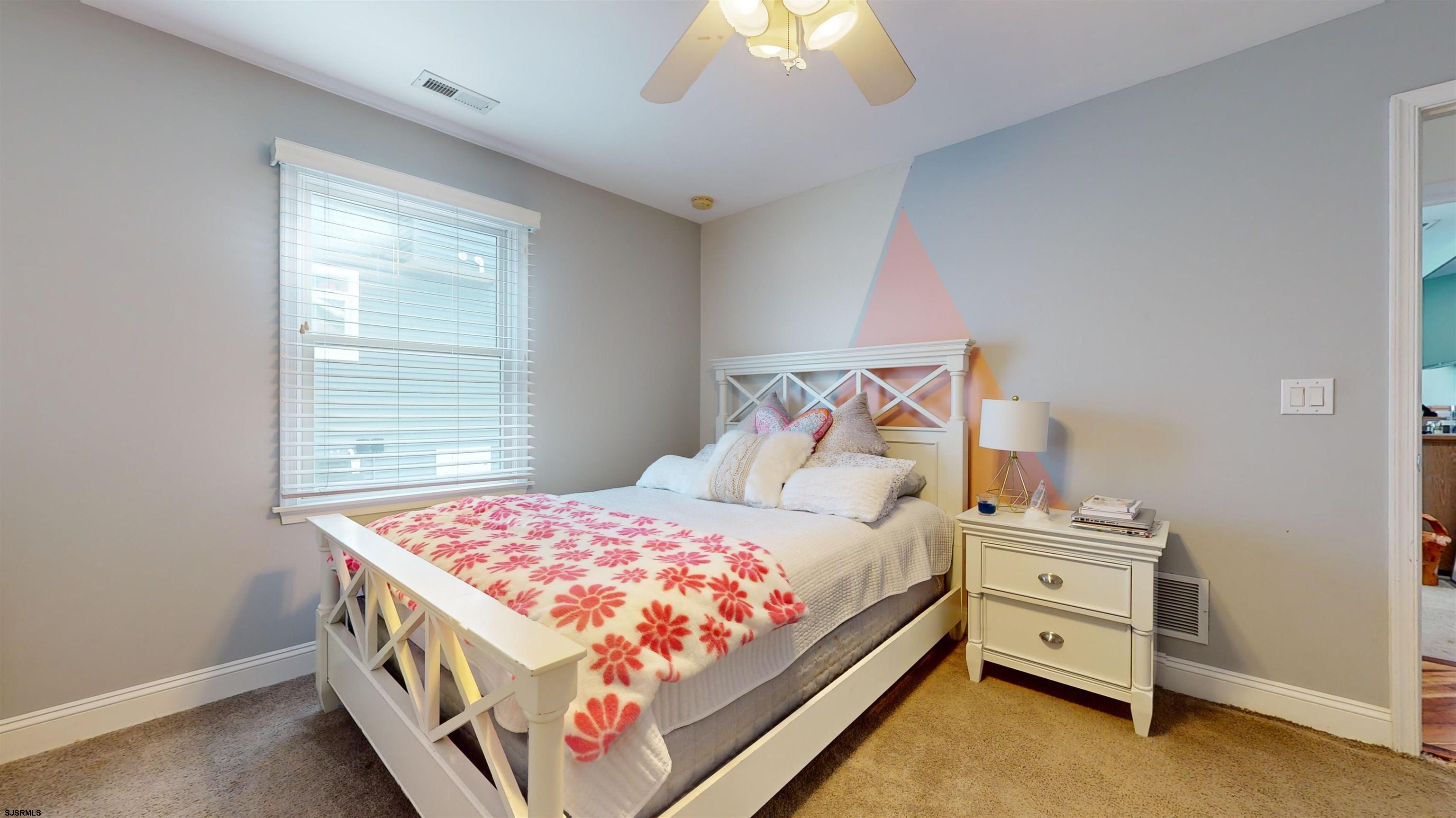 4205 Atlantic Brigantine Boulevard Brigantine, NJ 08203 - Photo 32 of 58 a bedroom with a bed and a window