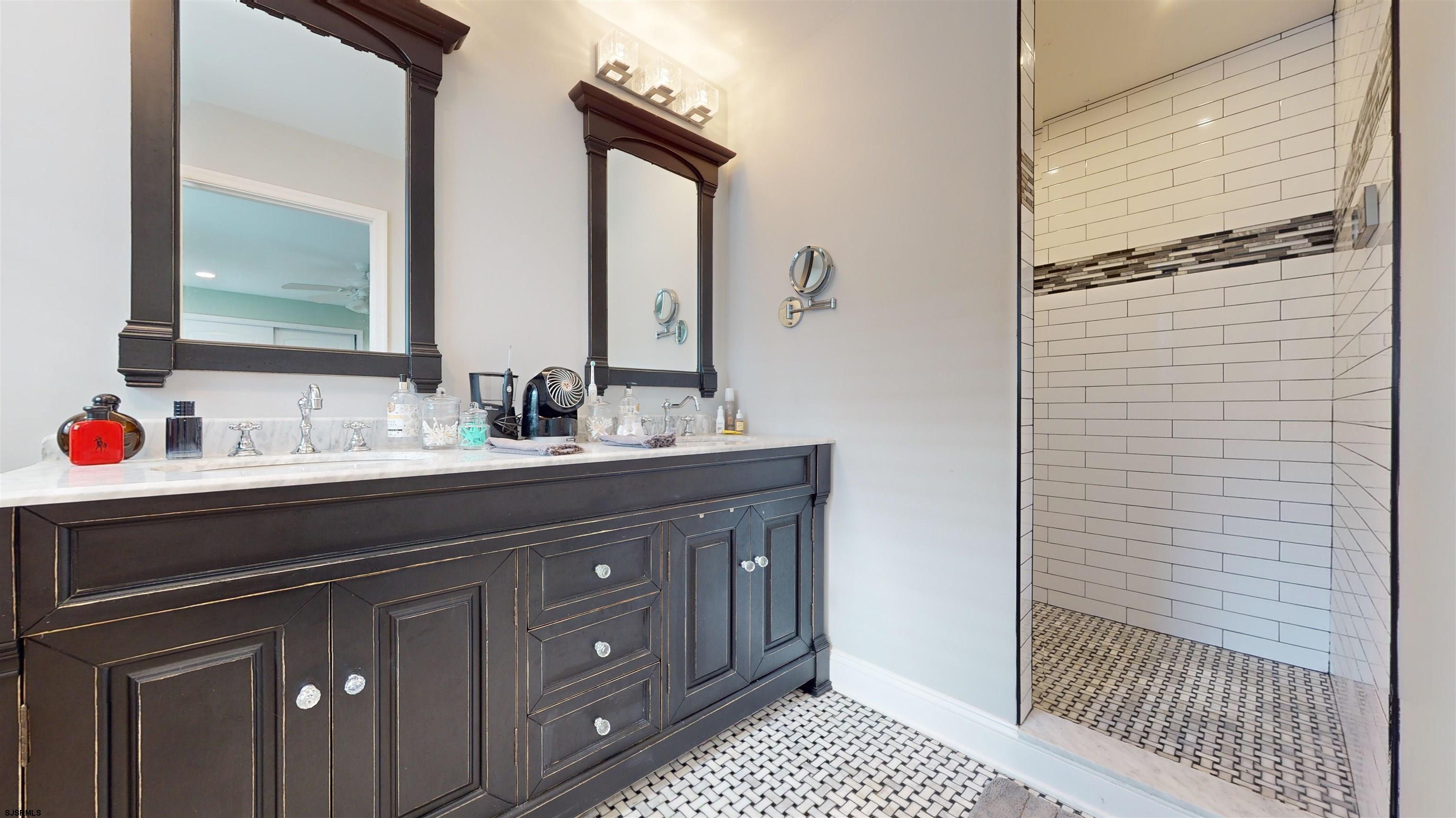 4205 Atlantic Brigantine Boulevard Brigantine, NJ 08203 - Photo 34 of 58 a bathroom with a sink and a mirror
