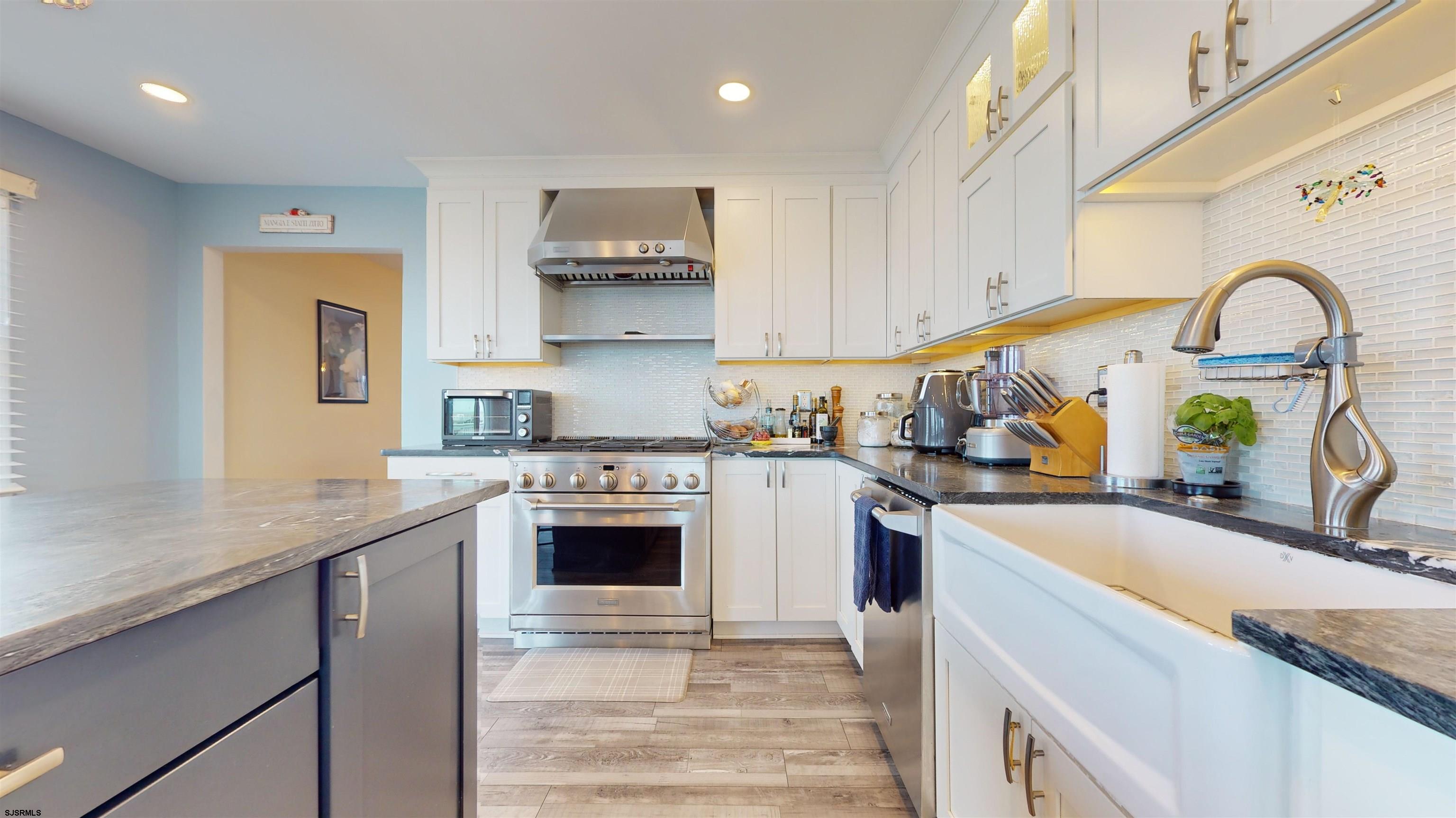 4205 Atlantic Brigantine Boulevard Brigantine, NJ 08203 - Photo 52 of 58 a kitchen with stainless steel appliances granite countertop a sink a stove and a refrigerator