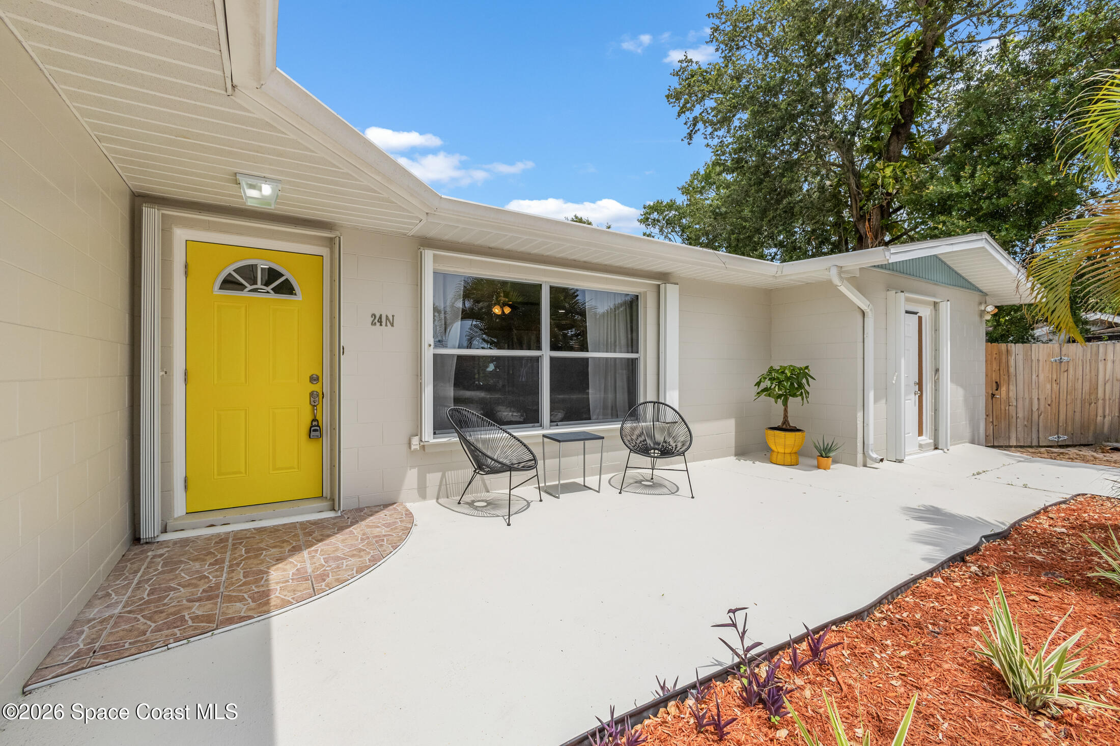 24 Hardee Circle South Rockledge, FL 32955 - Photo 1 of 6 a view of a patio with table and chairs and potted plants