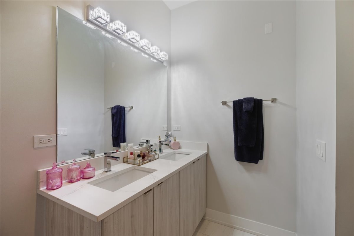 2317 North Clark Street, Unit 410 Chicago, IL 60614 - Photo 11 of 16 a bathroom with a sink and mirror