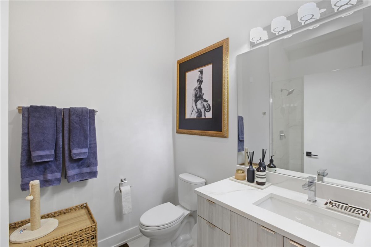 2317 North Clark Street, Unit 410 Chicago, IL 60614 - Photo 13 of 16 a bathroom with a toilet sink vanity granite and mirror