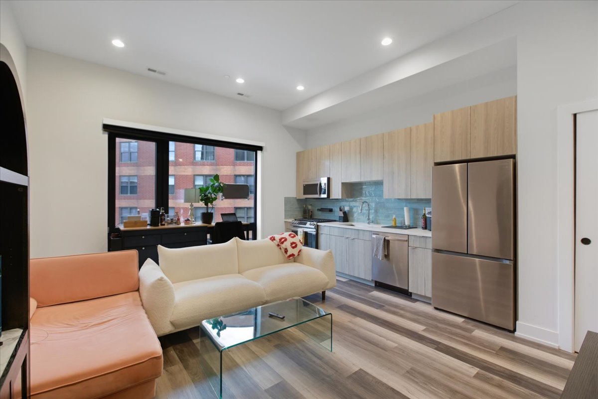 2317 North Clark Street, Unit 410 Chicago, IL 60614 - Photo 3 of 16 a dining room with furniture a large window and stainless steel appliances