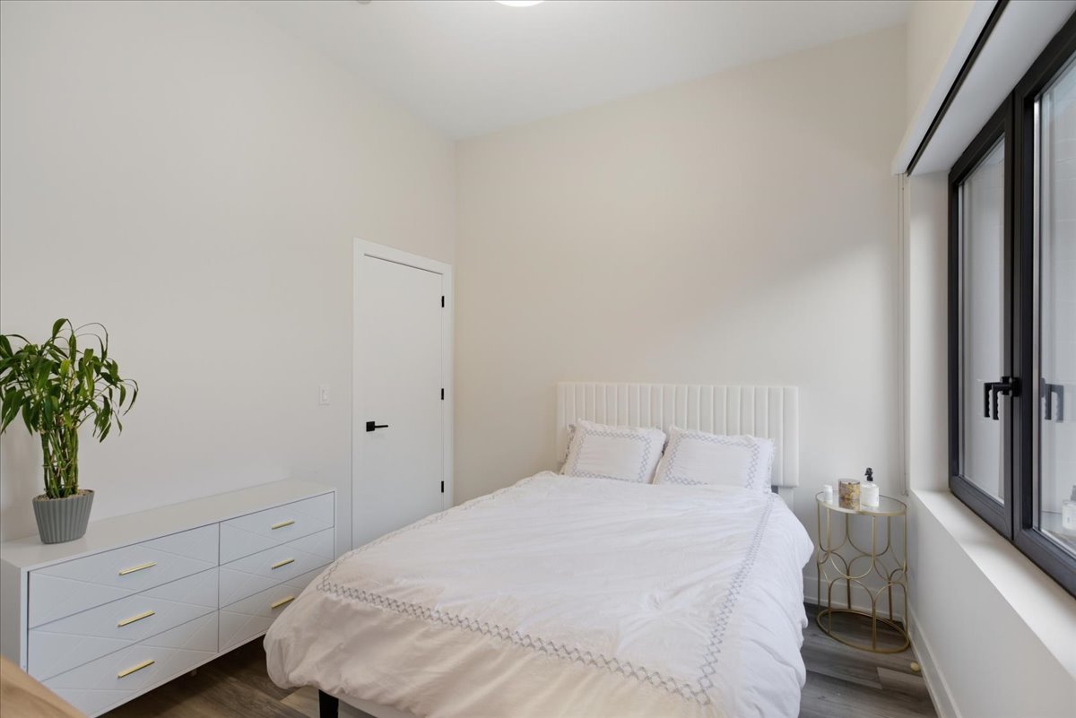 2317 North Clark Street, Unit 410 Chicago, IL 60614 - Photo 6 of 16 a bedroom with a bed and a potted plant on dresser