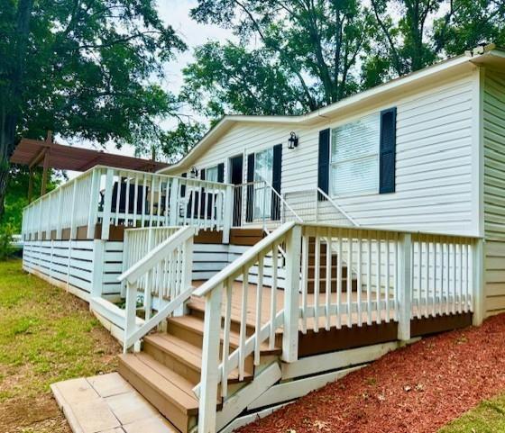 26 Skyland Drive West Locust Grove, GA 30248 - Photo 4 of 29 a view of a house with wooden deck