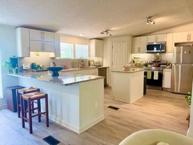 a kitchen with refrigerator and cabinets
