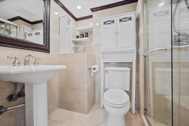 a bathroom with a sink toilet and shower