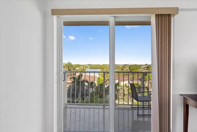 a view of a glass door with a balcony from a door
