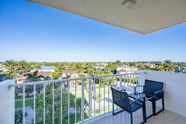 a view of a balcony with chair and city view