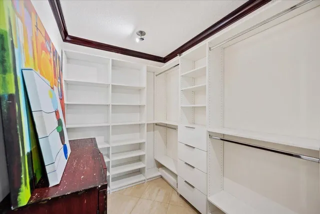 a view of walk in closet with empty racks
